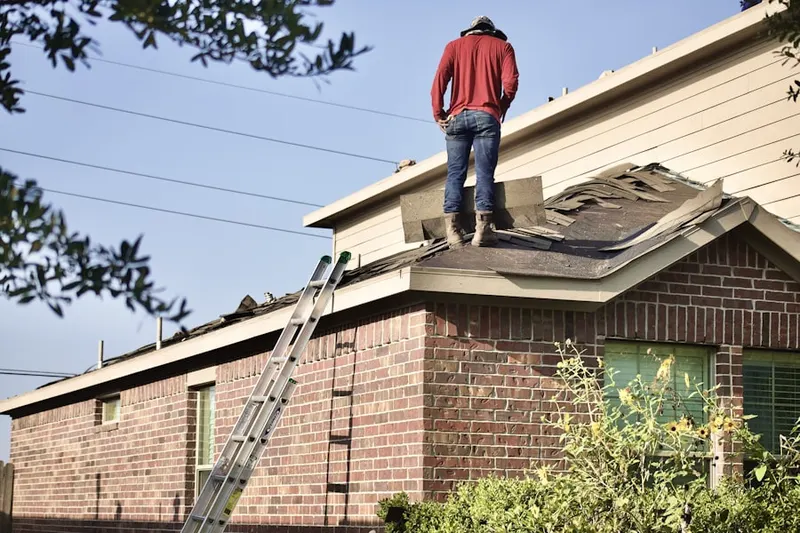 Professional roofer working on a residential roof in Belvedere